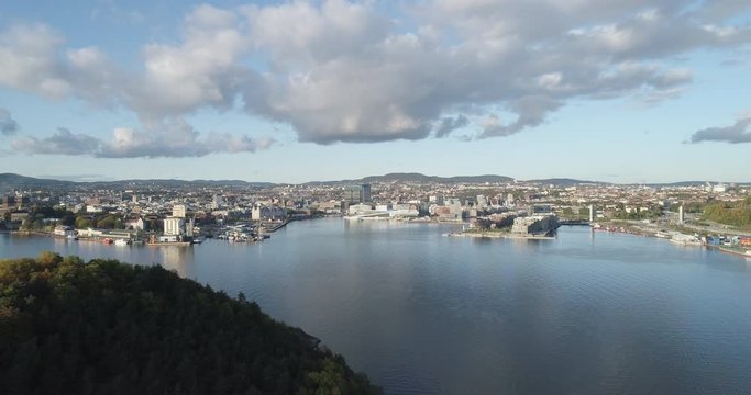Cinema 4K drone shot with parallax motion of Hoved&oslash;ya island, the Oslofjord and the new Bj&oslash;rvika quarter project with the Lambda Edvard Munch Museum and Opera House in autumn fall, in Oslo Norway.
