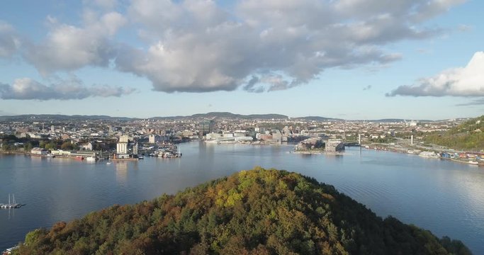 Cinema 4K drone shot with parallax motion of Hoved&oslash;ya island, the Oslofjord and the new Bj&oslash;rvika quarter project with the Lambda Edvard Munch Museum and Opera House in autumn fall, in Oslo Norway.