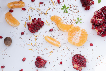 Winter Fruits Background - Pomegranate, Orange, Chai Tea on white Background