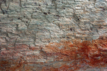 Stone background, rock wall backdrop with rough texture. Abstract, grungy and textured surface of stone material. Nature detail of rocks.