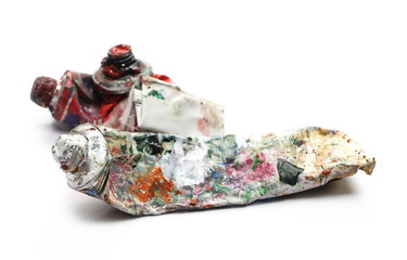 Messy, stained paint tubes isolated on white background