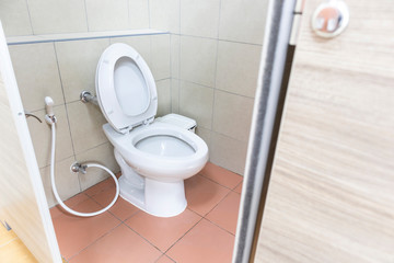 Toilet seat decoration in bathroom background. White toilet bowl in the bathroom.