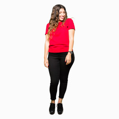 Young beautiful woman wearing casual t-shirt looking away to side with smile on face, natural expression. Laughing confident.