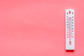 Weather thermometer on pink background top view copy space