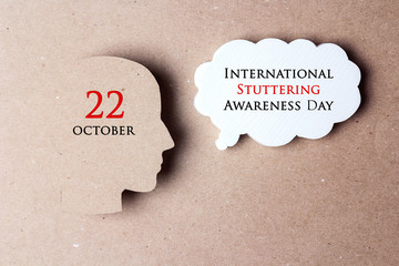 International Stuttering Awareness day, 22 October. Face profile silhouette with speech bubble on a...