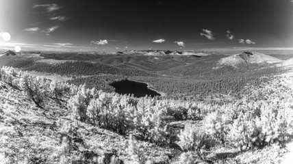 infrared forest with clouds, sky and mountains