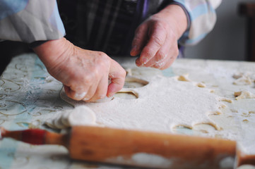 Woman molds Ukrainian dumplings.Ukrainian traditional dish