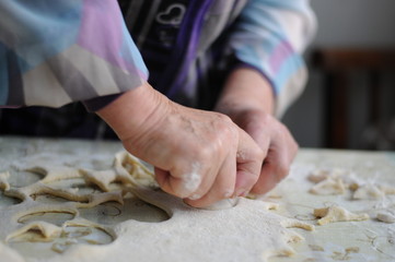Woman molds Ukrainian dumplings.Ukrainian traditional dish