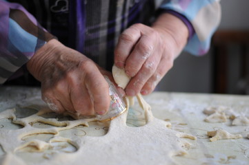Woman molds Ukrainian dumplings.Ukrainian traditional dish