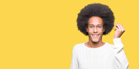 Young african american man with afro hair wearing glasses Doing Italian gesture with hand and fingers confident expression