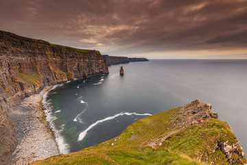 reland countryside tourist attraction in County Clare. The Cliffs of Moher and castle Ireland. Epic Irish Landscape UNESCO Global Geopark the wild atlantic way. Beautiful scenic nature hdr Ireland.