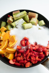 Rhubarb, strawberry and orange in a pan for making homemade jam