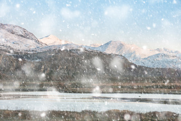 Beautiful Winter sunrise landscape image of Mount Snowdon and other peaks in Snowdonia National...