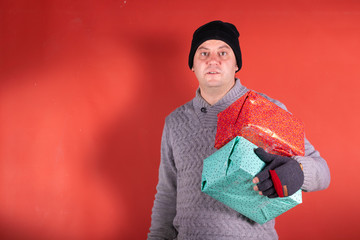 Chico con regalos de navidad feliz y sorprendido 