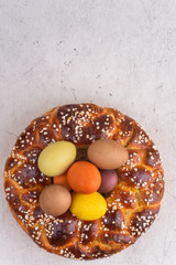 Easter brioche with cream and natural colored eggs