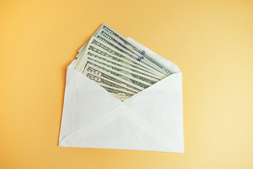 Close up Beautiful Dollars in the envelope on a yellow Background. American, US Dollars Cash Money....