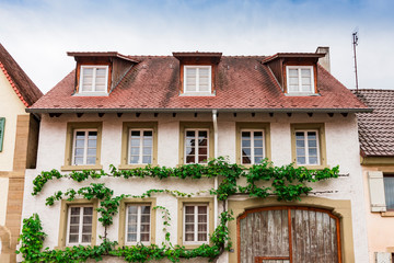 White house with orange roof tiles and green leaves.  Eppingen, Germany