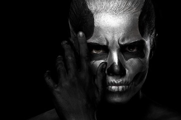 Halloween. Woman in day of the dead mask skull face art. Halloween face art on black background....