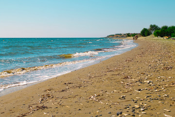 Beach view. Seashore texture. line water foam over clean sand and blue water. Hirozontal