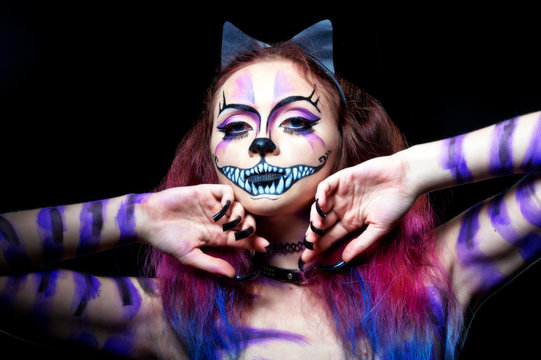 Beautiful young woman dressed as a cat. Make up cat. Halloween