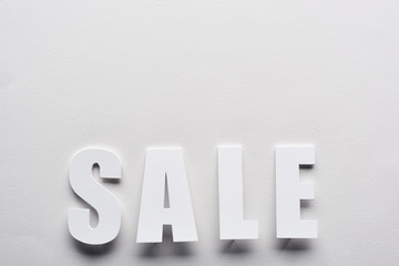 top view of white sale lettering on white background
