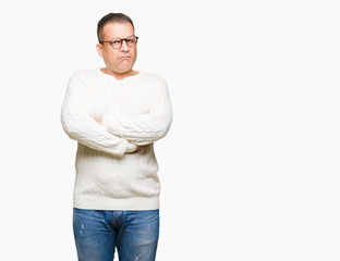Fototapeta premium Middle age arab man wearing glasses over isolated background skeptic and nervous, disapproving expression on face with crossed arms. Negative person.