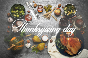 Flat lay composition with delicious roasted turkey on grey table. Happy Thanksgiving day