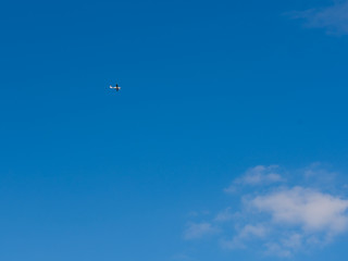 Small plane in the blue sky.