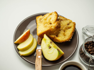 Jabłkowe ciasto pokrojone na talerzu. Plasterki jabłka. Widok z góry, jasne tło.