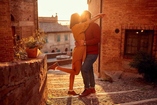 romantic couple kissing outdoor at the sunset.