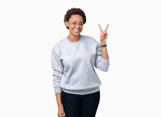 Young beautiful african american woman wearing glasses over isolated background smiling with happy...