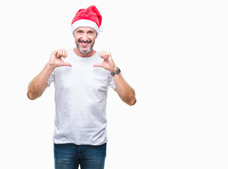 Middle age hoary senior man wearing christmas hat over isolated background looking confident with smile on face, pointing oneself with fingers proud and happy.