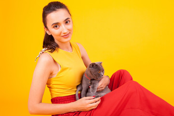 Smiling beautiful female holding her adorable cat