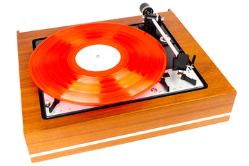 Vintage turntable with a red vinyl isolated on white