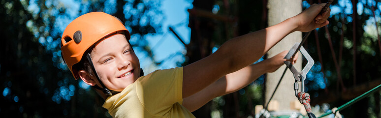 panoramic shot of boy in orange helmet outside