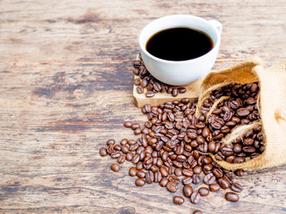 Coffee beans are spilling from the bag, ready to give freshness and alongside the businessman