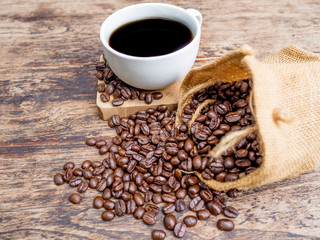 Coffee beans are spilling from the bag, ready to give freshness and alongside the businessman