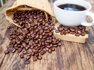 Coffee beans are spilling from the bag, ready to give freshness and alongside the businessman