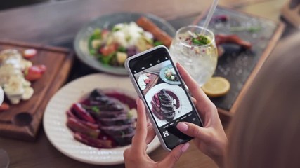 Influencer taking pictures of her food for her social media handle