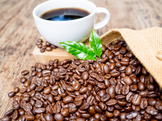 Coffee beans are spilling from the bag, ready to give freshness and alongside the businessman