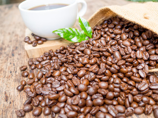 Coffee beans are spilling from the bag,  ready to give freshness and alongside the businessman
