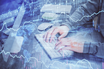 Double exposure of financial graph with man works in office on background. Concept of analysis.