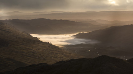 Fototapeta na wymiar Low lying cloud inversion in a Welsh mountain valley in the UK at dawn