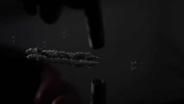 Cocaine being snorted off mirror macro slow motion