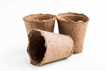 Pots for seedlings of ecological cardboard. Peat seed pots. Pots on isolated white background.