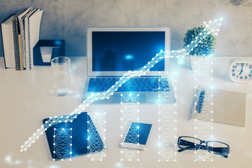 Financial graph colorful drawing and table with computer on background. Double exposure. Concept of international markets.