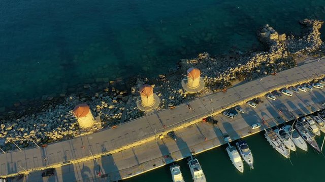 Aerial birds eye view drone video of Rhodes city island, Dodecanese, Greece. Panorama with Mandraki port, lagoon and clear blue water. Famous tourist destination in South Europe.
