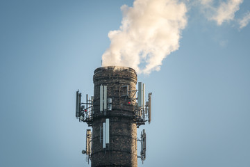 Top of high industrial chimney with multiple antennas