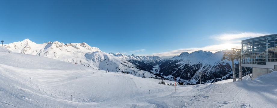 Alpin winter landscape  of St Anton with slopes an a cable car