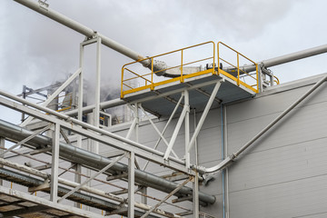 upper part of an industrial building with stairs, railings